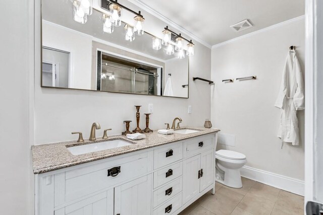 11 Poplar St, Porterdale, GA 30014 - bathroom with a shower stall, toilet, double vanity, ornamental molding, and tile patterned flooring