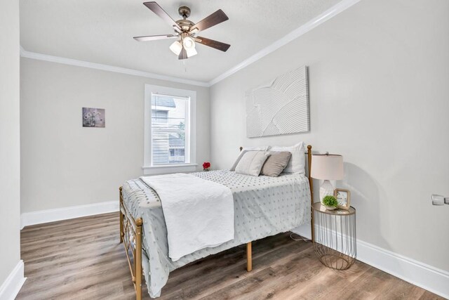 11 Poplar St, Porterdale, GA 30014 - bedroom with baseboards, ornamental molding, wood finished floors, and ceiling fan