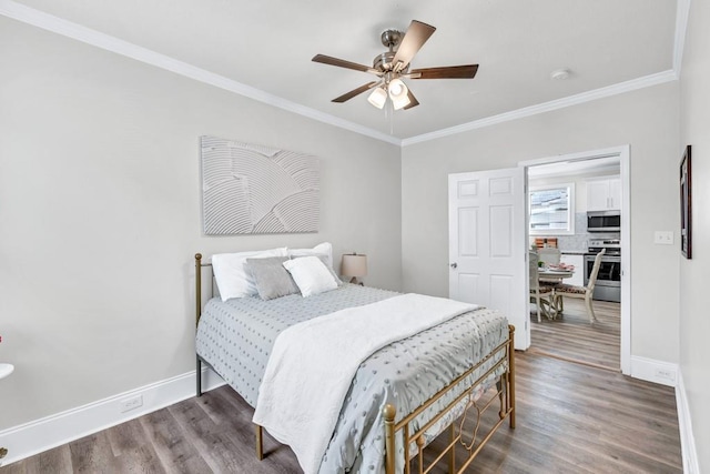11 Poplar St, Porterdale, GA 30014 - bedroom featuring baseboards, crown molding, wood finished floors, and a ceiling fan