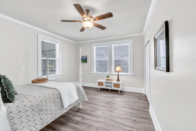 11 Poplar St, Porterdale, GA 30014 - bedroom featuring ornamental molding, wood finished floors, baseboards, and ceiling fan