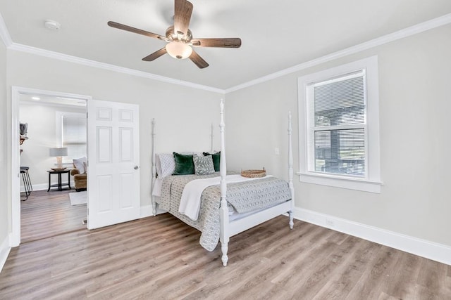 11 Poplar St, Porterdale, GA 30014 - bedroom with baseboards, light wood finished floors, crown molding, and a ceiling fan