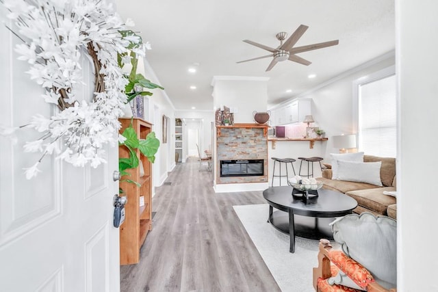 11 Poplar St, Porterdale, GA 30014 - living room featuring ornamental molding, light wood-style floors, a ceiling fan, recessed lighting, and a glass covered fireplace