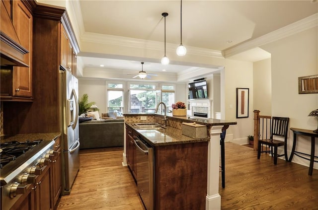 225 Mystic Ridge Hl, Sandy Springs, GA 30342 - kitchen featuring stainless steel appliances, open floor plan, a kitchen bar, a sink, and dark stone countertops
