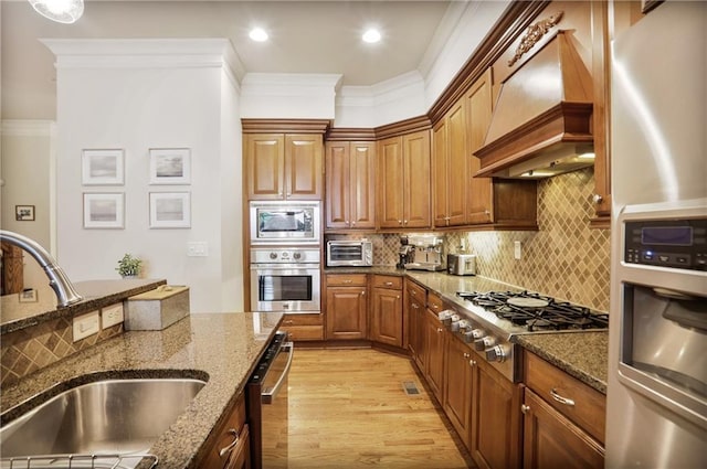 225 Mystic Ridge Hl, Sandy Springs, GA 30342 - kitchen featuring appliances with stainless steel finishes, a sink, custom range hood, ornamental molding, and dark stone counters