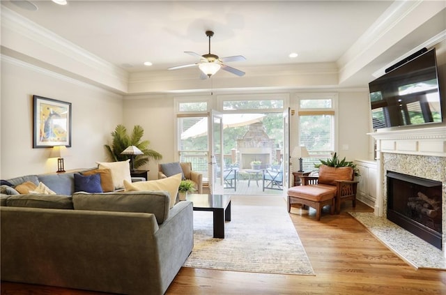 225 Mystic Ridge Hl, Sandy Springs, GA 30342 - living room featuring ornamental molding, wood finished floors, a tray ceiling, a ceiling fan, and a premium fireplace