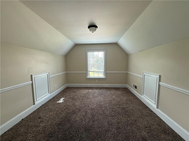 381 Plymstock Dr, Mcdonough, GA 30253 - bonus room featuring lofted ceiling, carpet flooring, and baseboards