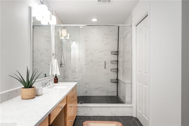 bathroom featuring vanity, tile patterned floors, and walk in shower