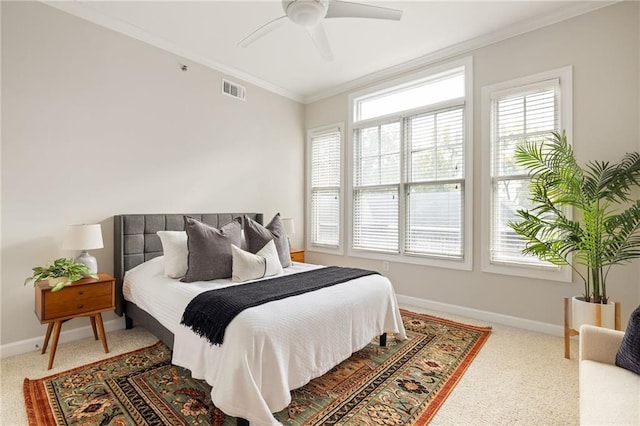 carpeted bedroom featuring crown molding and ceiling fan