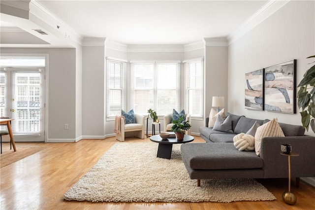 living room featuring ornamental molding, hardwood / wood-style floors, and a wealth of natural light