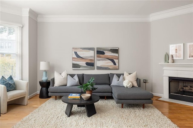 living room featuring ornamental molding, hardwood / wood-style flooring, and a tile fireplace