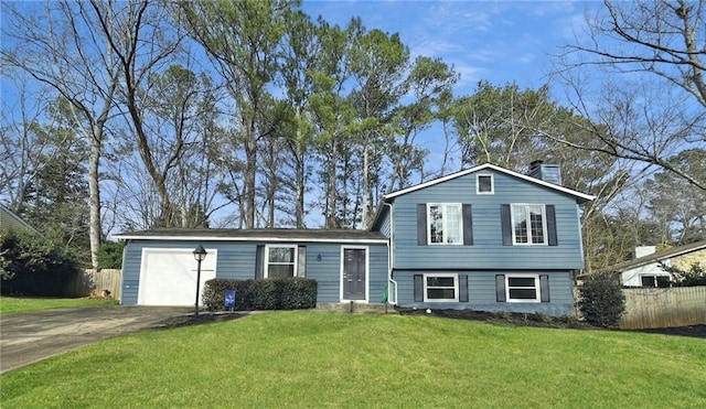 split level home with a garage and a front lawn