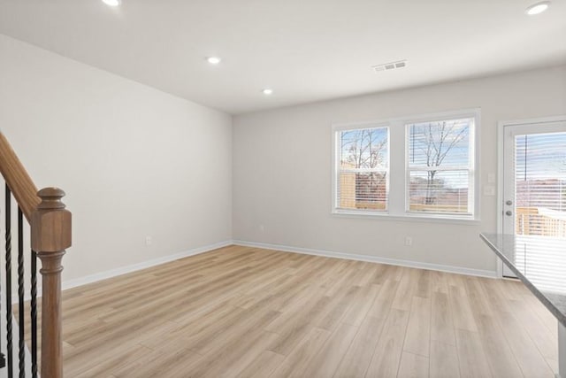 spare room with light hardwood / wood-style flooring