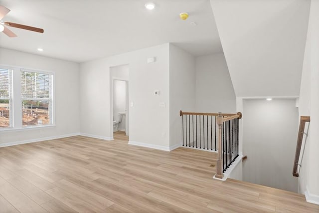 empty room with ceiling fan and light wood-type flooring