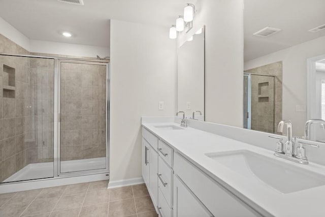 bathroom with tile patterned floors, an enclosed shower, and vanity