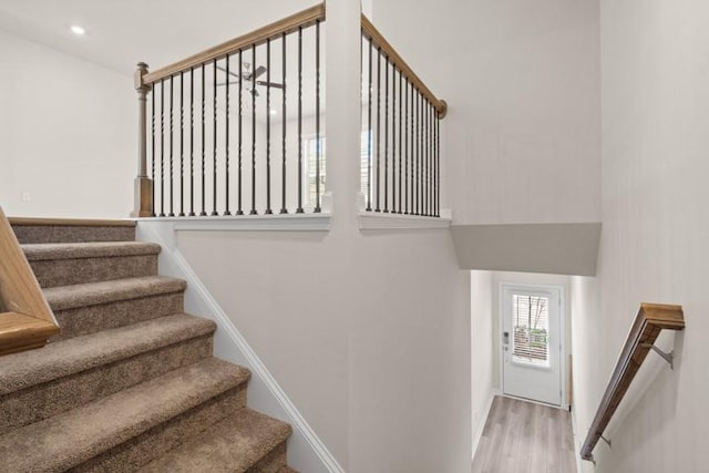 staircase with hardwood / wood-style floors