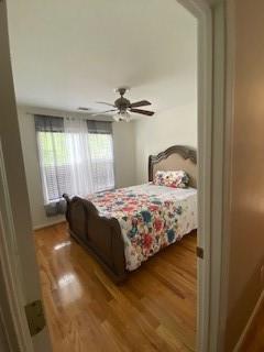 bedroom featuring hardwood / wood-style floors and ceiling fan