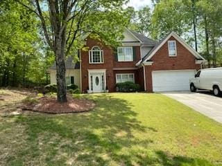 view of front of property with a front yard and a garage