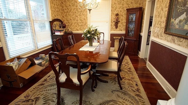 dining space with a chandelier and dark hardwood / wood-style flooring