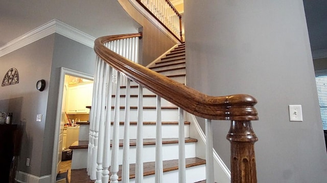 stairs featuring crown molding