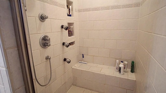 bathroom with a tile shower