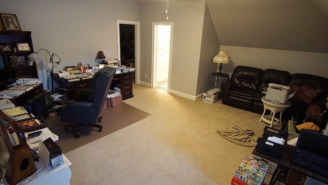 home office with light carpet and vaulted ceiling