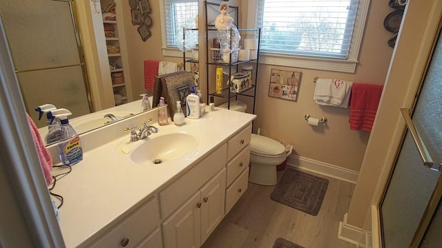 bathroom with toilet, hardwood / wood-style floors, oversized vanity, and an enclosed shower