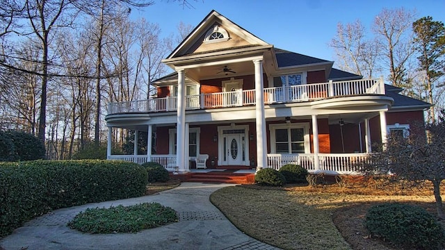 neoclassical / greek revival house with ceiling fan, a balcony, and a porch