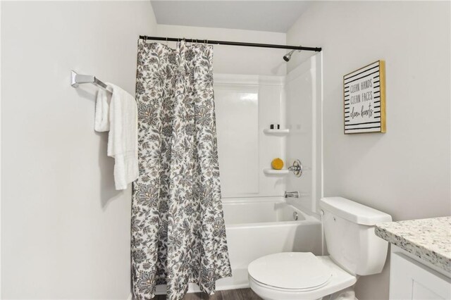 full bathroom with shower / tub combo, hardwood / wood-style flooring, vanity, and toilet