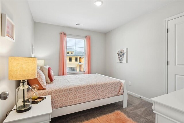 bedroom featuring dark carpet