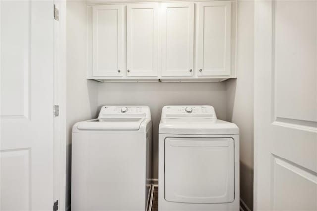 2527 Swan Lake Dr, Grayson, GA 30017 - clothes washing area featuring cabinet space and washer and dryer