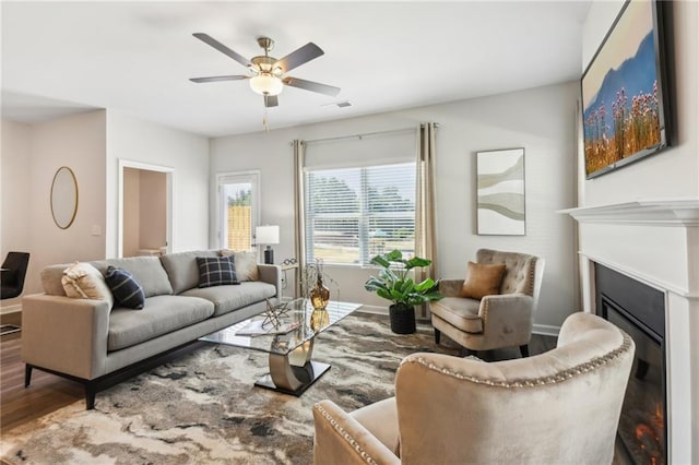 2527 Swan Lake Dr, Grayson, GA 30017 - living area featuring visible vents, a glass covered fireplace, wood finished floors, baseboards, and a ceiling fan