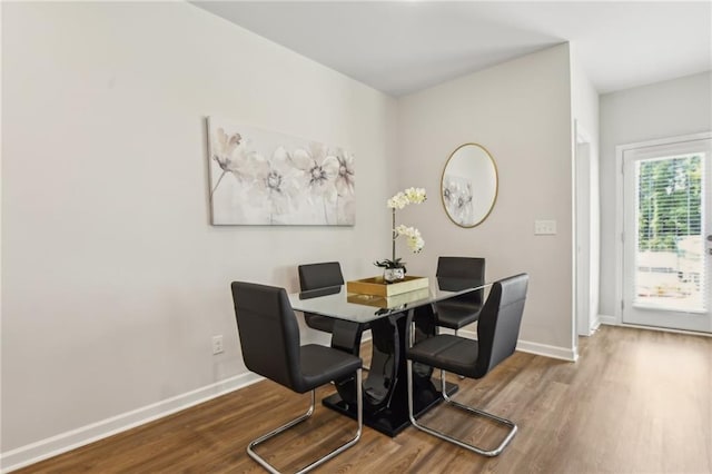 dining space with hardwood / wood-style floors