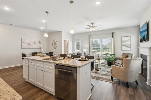 2527 Swan Lake Dr, Grayson, GA 30017 - kitchen with dark wood-style flooring, stainless steel dishwasher, a sink, white cabinets, and open floor plan