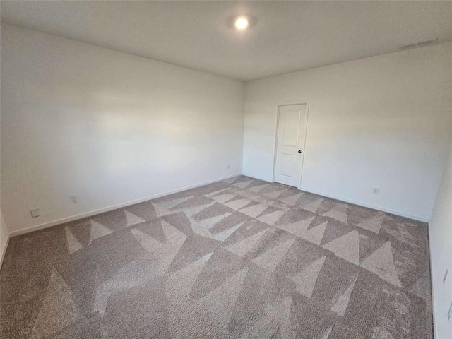 carpeted empty room with baseboards