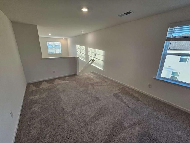 spare room featuring baseboards, visible vents, carpet flooring, and recessed lighting