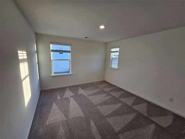 empty room with carpet floors and baseboards