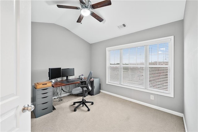 carpeted office space featuring lofted ceiling, visible vents, ceiling fan, and baseboards