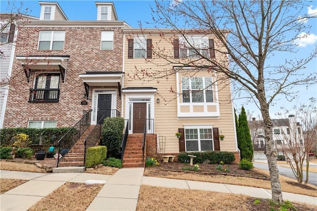 townhome / multi-family property with brick siding