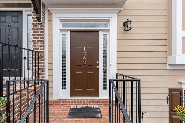 doorway to property with brick siding