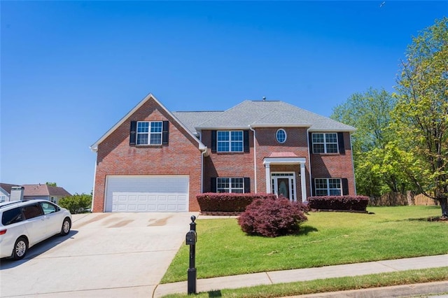 view of front of property featuring concrete driveway, a front lawn, brick siding, and a garage