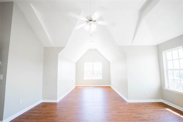 bonus room with wood finished floors, baseboards, and ceiling fan