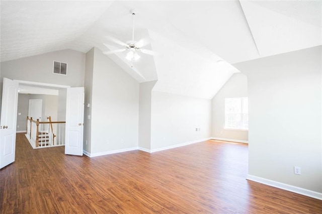 bonus room with lofted ceiling, wood finished floors, visible vents, a ceiling fan, and baseboards