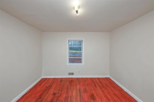 unfurnished room with hardwood / wood-style floors