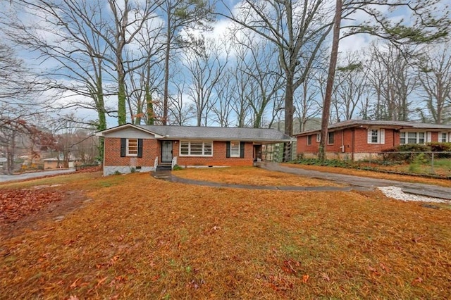 ranch-style house featuring a carport