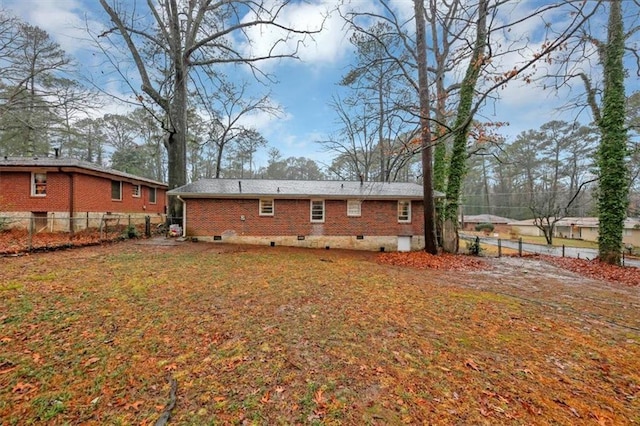 rear view of property featuring a yard