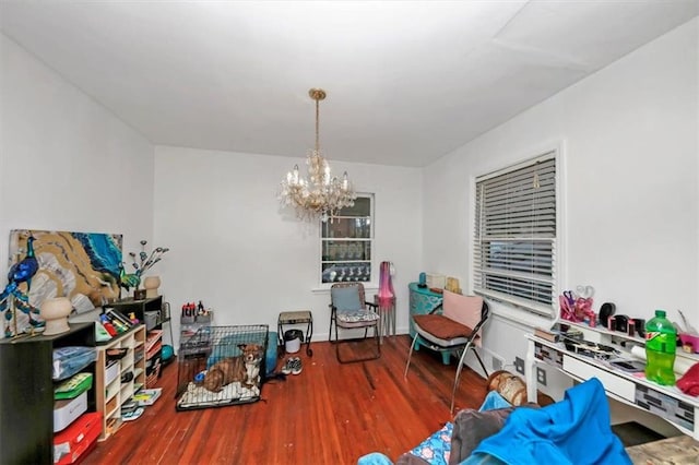 game room with a chandelier and hardwood / wood-style floors