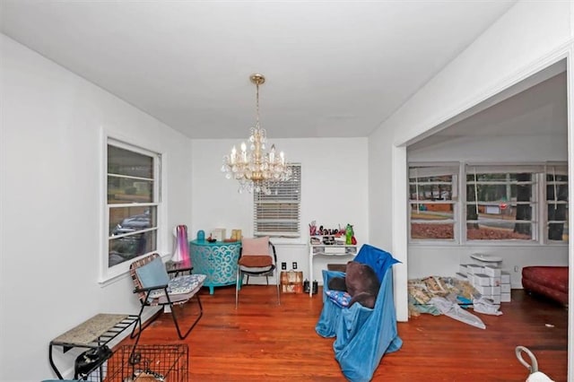 interior space with an inviting chandelier and hardwood / wood-style flooring