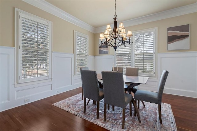 dining space with crown molding, dark hardwood / wood-style floors, and a chandelier