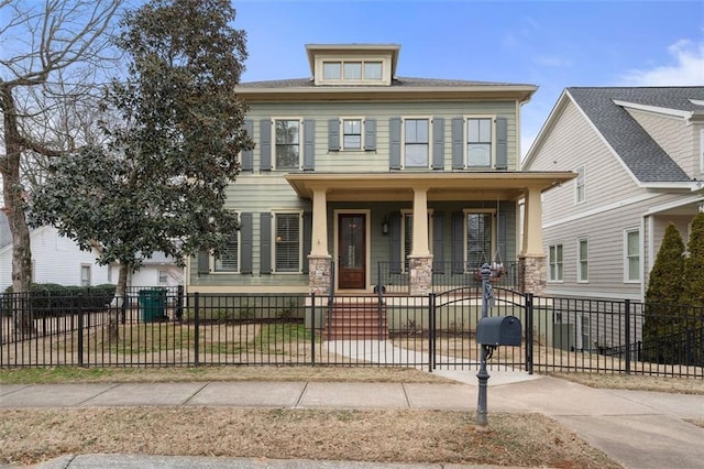 traditional style home featuring a fenced front yard and covered porch