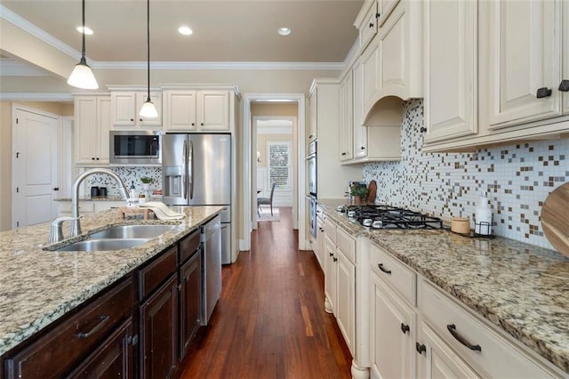 kitchen with appliances with stainless steel finishes, sink, custom exhaust hood, and white cabinets